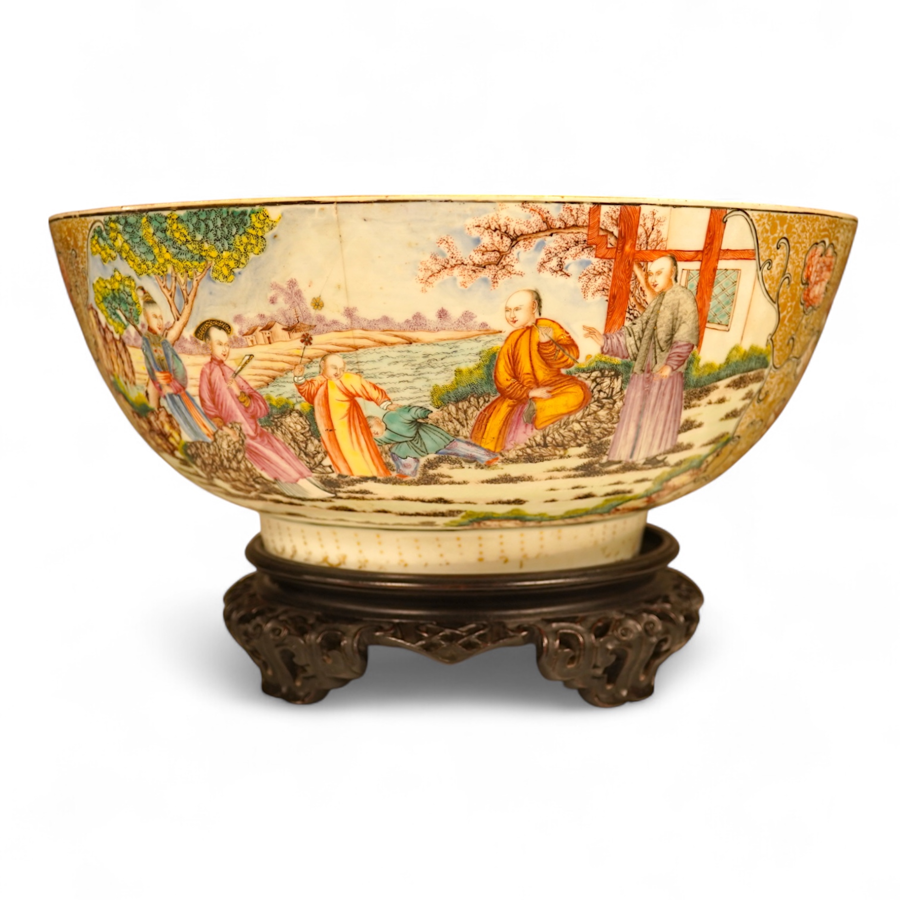 An 18th century Chinese famille rose figural bowl, on wooden stand, 34cm diameter.